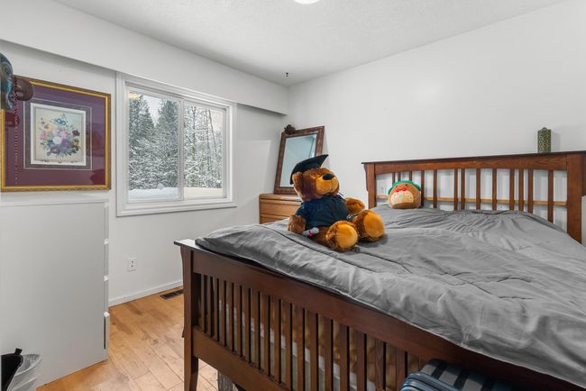 Bedroom with visible vents, baseboards, and wood-type flooring | Image 18