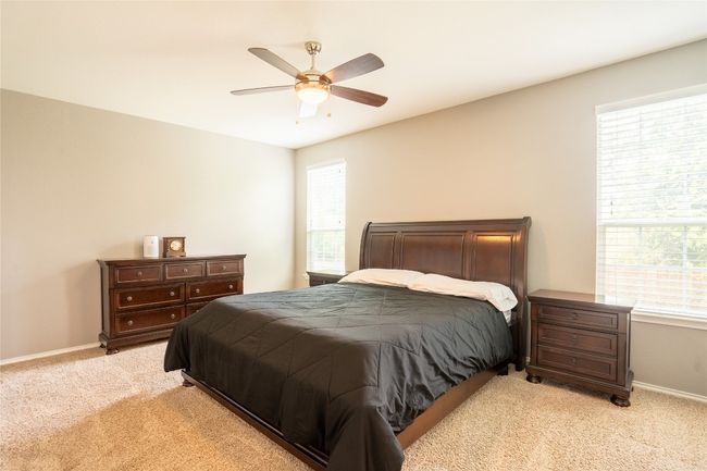 Bedroom with light carpet and ceiling fan | Image 14