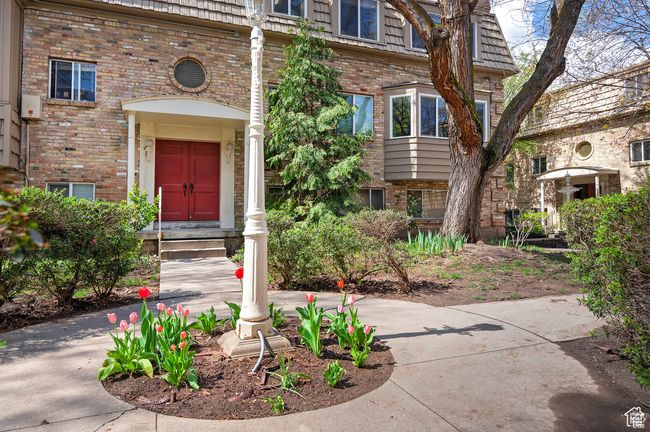 Entrance to property featuring brick siding and mansard roof | Image 24