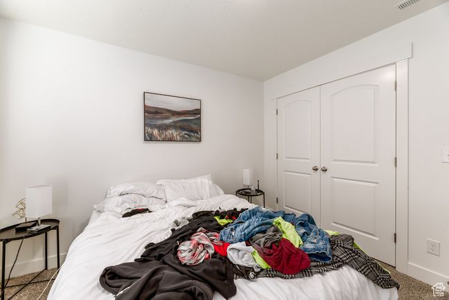 Bedroom with carpet flooring, visible vents, a closet, and baseboards | Image 19