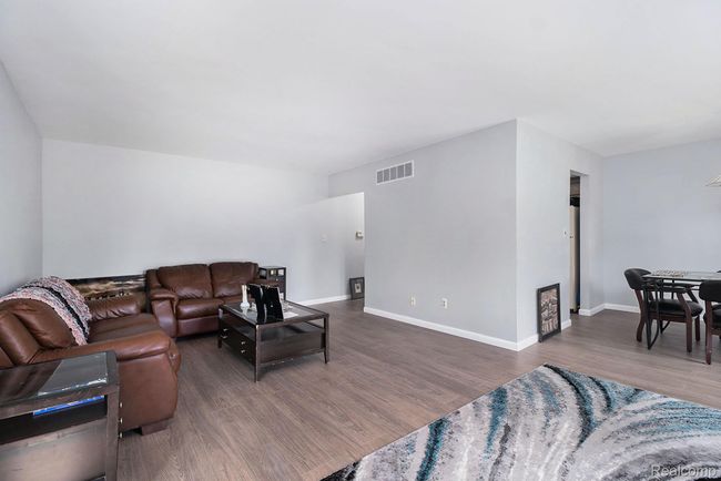 Living area with wood finished floors and baseboards | Image 4