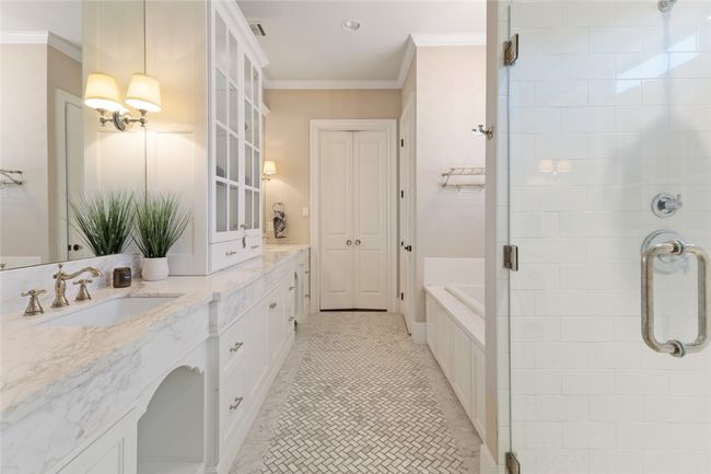 Bathroom with a stall shower, crown molding, double vanity, a garden tub, and tile patterned flooring | Image 11