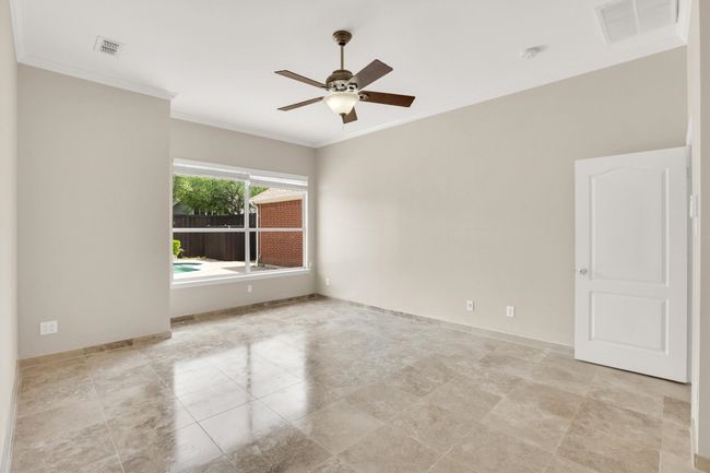 Spare room with visible vents, ornamental molding, baseboards, and ceiling fan | Image 35