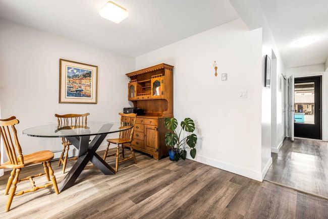 Dining area with baseboards and wood finished floors | Image 13