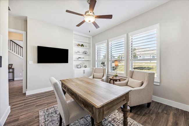 Handsome Study/ Home Office has a custom built in book case & cabinets for storage. | Image 5