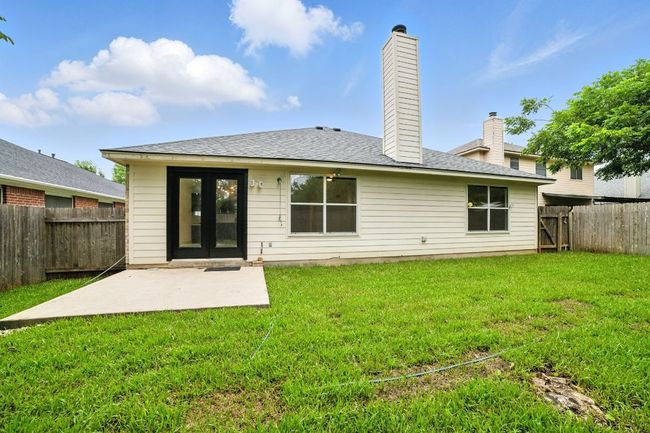 Step outside to a private backyard oasis with a concrete patio, new sod, and a full wood privacy fence—ideal for relaxing or entertaining outdoors. | Image 26