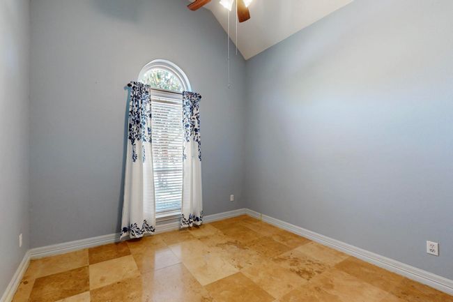 Empty room with baseboards, a ceiling fan, plenty of natural light, and lofted ceiling | Image 27