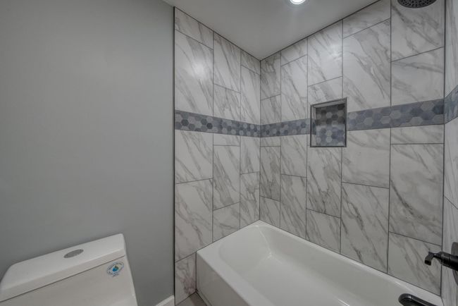 Bathroom with toilet and shower / tub combination | Image 23