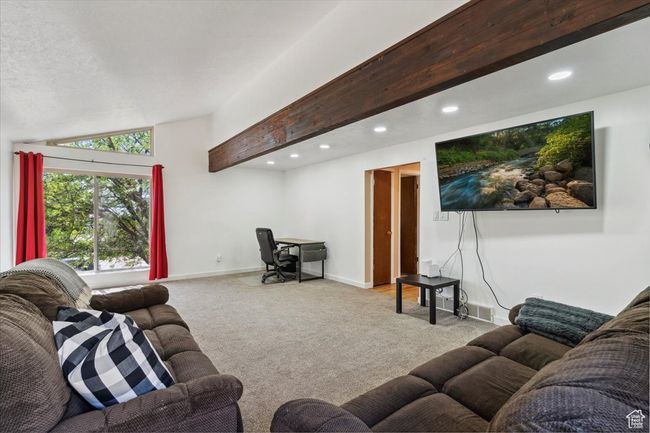 Carpeted living room featuring vaulted ceiling and recessed lighting | Image 12