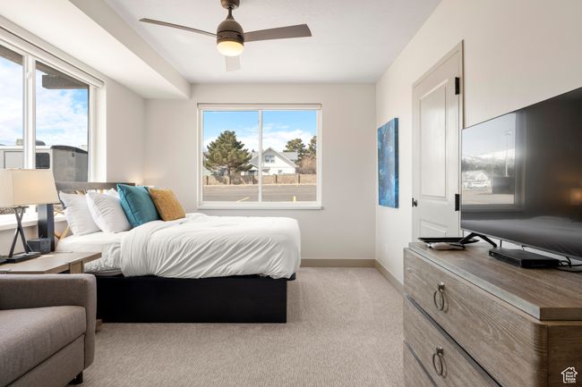 Bedroom with baseboards, light colored carpet, and a ceiling fan | Image 37