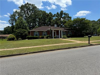 Ranch-style home with a front lawn | Image 1