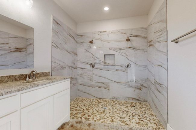 Bathroom featuring recessed lighting, vanity, and a marble finish shower | Image 28