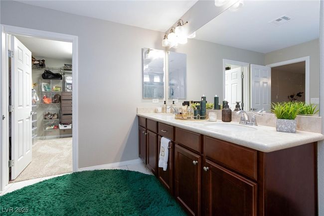 Full bathroom featuring double vanity, a sink, visible vents, and carpet | Image 26