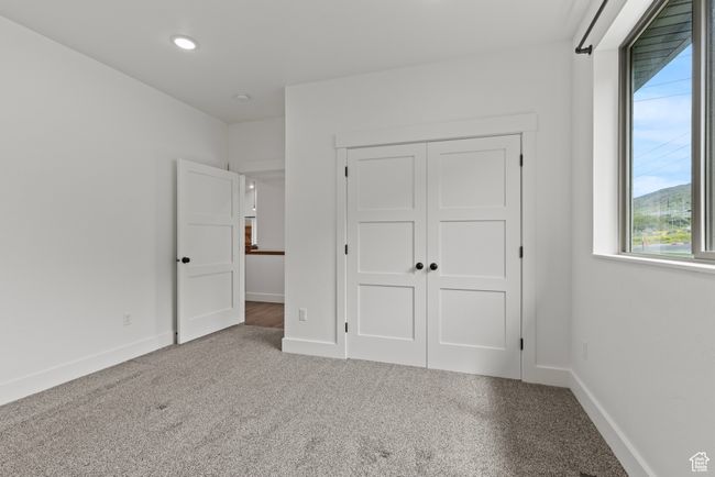 Unfurnished bedroom with carpet, baseboards, a closet, and recessed lighting | Image 22