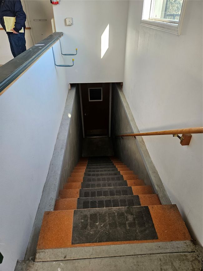 This set of stairs leads to the basement which has one bedroom and one bathroom and PLENTY OF STORAGE! A dark room plus two wood working shops | Image 23