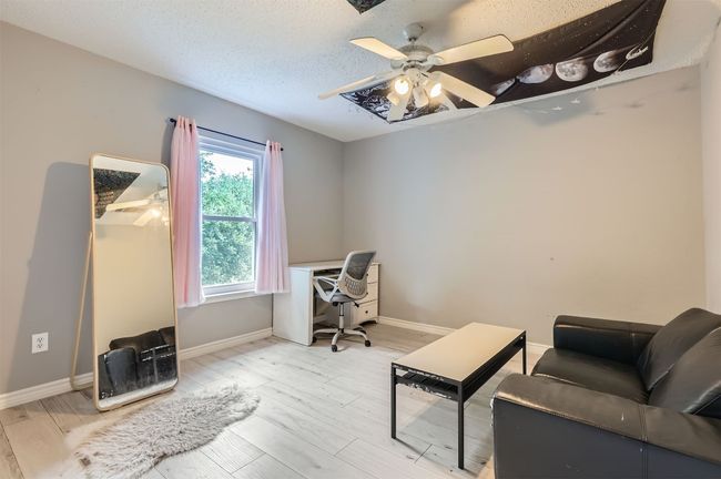 Office space with a ceiling fan, baseboards, and light wood-style floors | Image 22