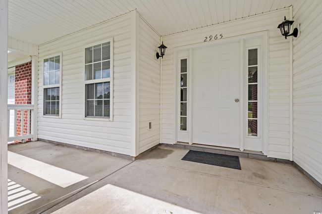 Doorway to property featuring a porch | Image 4