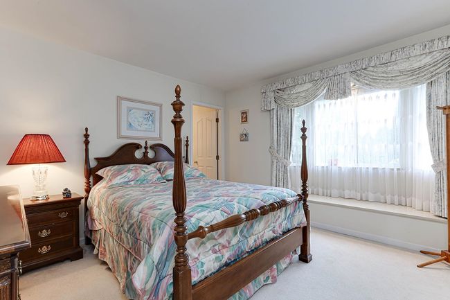 Bedroom with baseboards and light colored carpet | Image 32