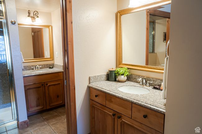 Full bathroom featuring a stall shower, vanity, and tile patterned floors | Image 16