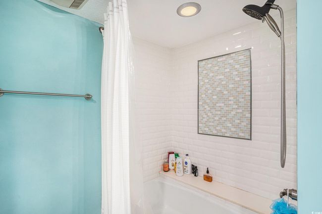 Bathroom featuring shower / tub combo with curtain | Image 18