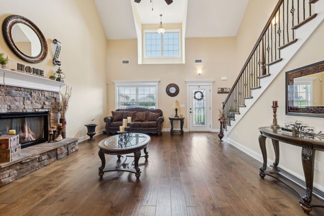 The spacious living room features soaring grand ceilings and gleaming finished hardwood floors. 1107 Sycamore Leaf Way Murfreesboro, TN 37129 | Image 4