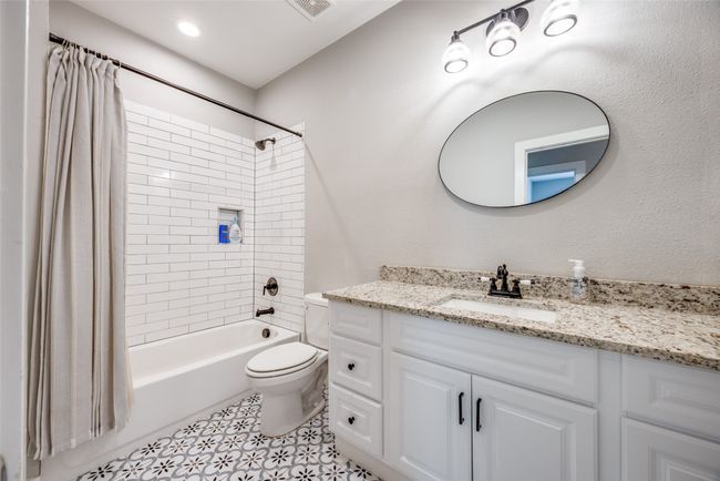 Full bath with vanity, shower / bathtub combination with curtain, and toilet | Image 9
