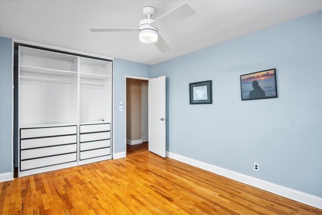 Unfurnished bedroom with a closet, light wood-type flooring, and ceiling fan | Image 19