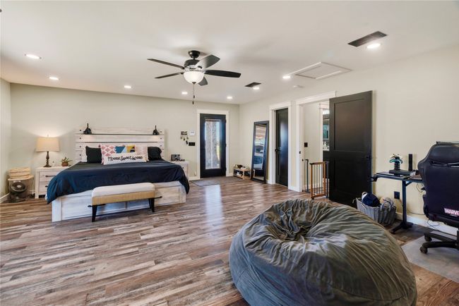 Bedroom featuring attic access, recessed lighting, baseboards, visible vents, and wood finished floors | Image 10