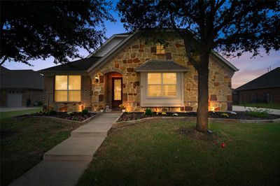 Front facade featuring a lawn and a garage | Image 2