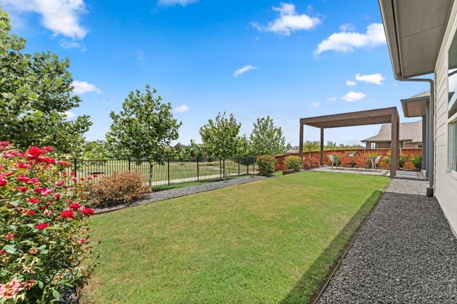 The backyard opens to peaceful greenbelt views, offering a private retreat. | Image 19