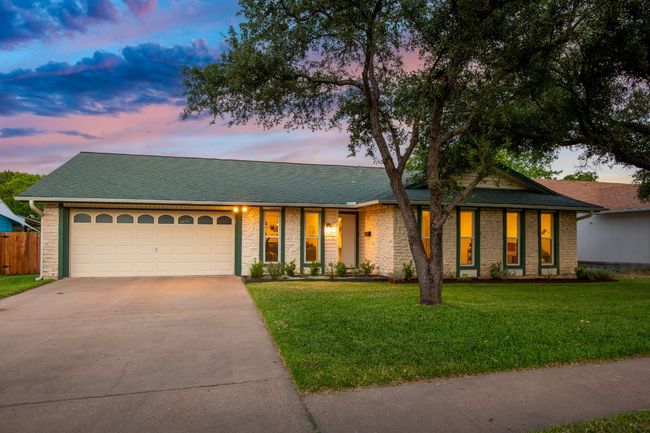 View of front of house with driveway, a garage, a shingled roof, and brick siding | Image 22