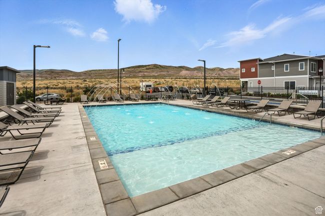 Community pool with a mountain view and a patio | Image 21