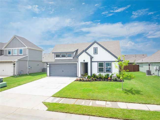 View of front of house featuring board and batten siding, concrete driveway, roof with shingles, and an attached garage | Image 4
