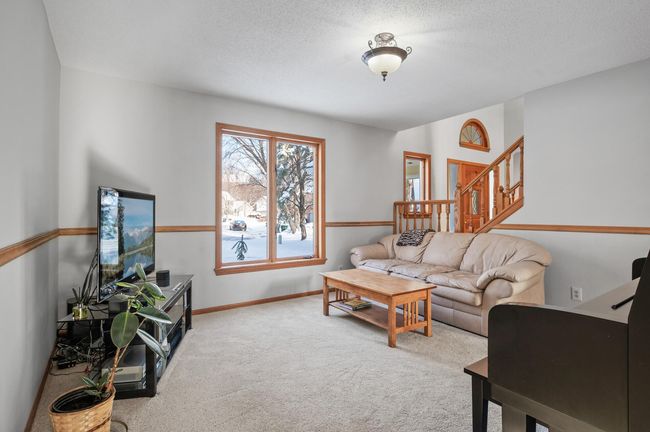 The formal dining room is adjacent to the kitchen and is currently being used as a living space. | Image 13