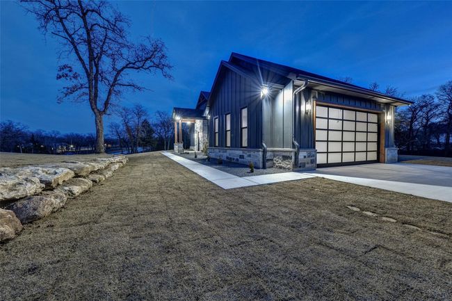 Property exterior at dusk with a garage | Image 36