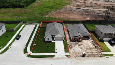 This home sits on a large corner lot with ample yard space in front and the back, lush landscaping and a well-maintained yard. | Image 2