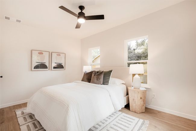Bedroom featuring light wood-type flooring and a ceiling fan | Image 18