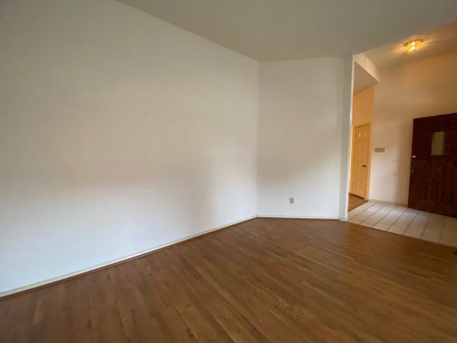 Spare room with wood finished floors and baseboards | Image 6