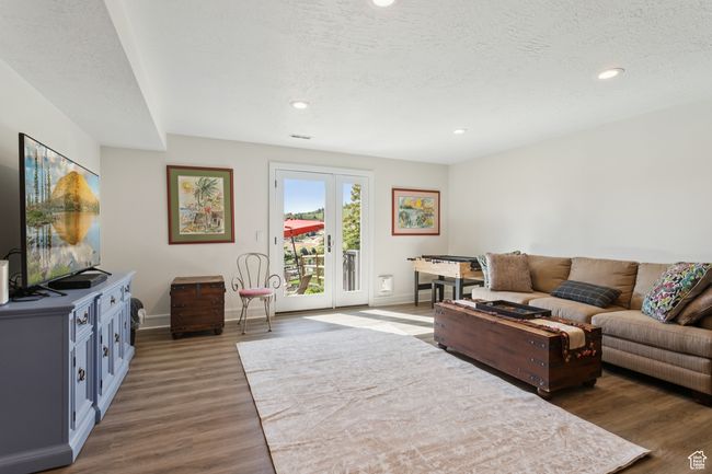 Living area with wood finished floors and recessed lighting | Image 24