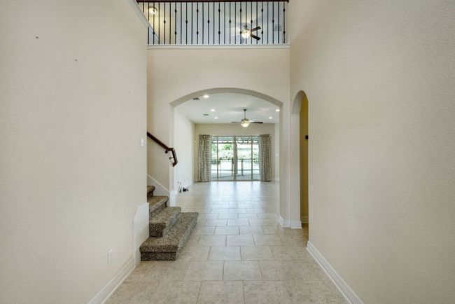 Entryway with arched walkways, a high ceiling | Image 5