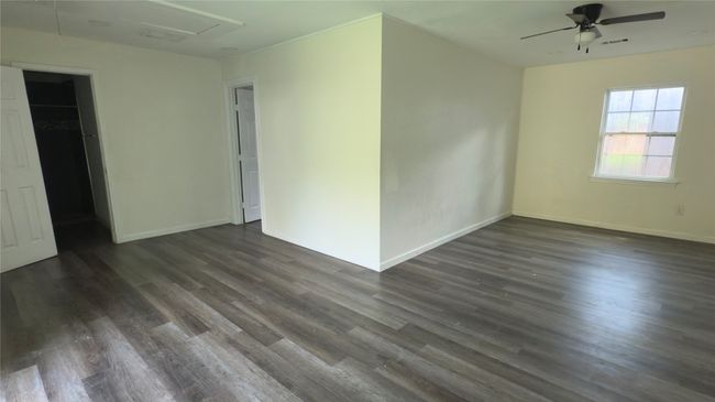 Unfurnished living room with dark wood-style flooring and a ceiling fan | Image 21
