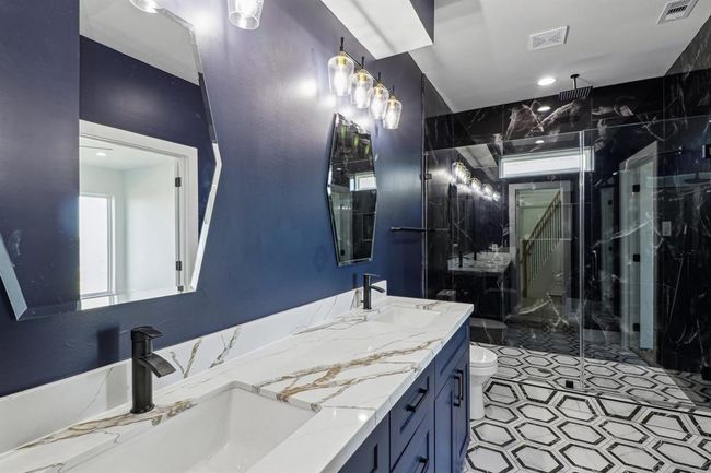 Custom primary bath with rain shower and double vanities for ultimate relaxation | Image 16