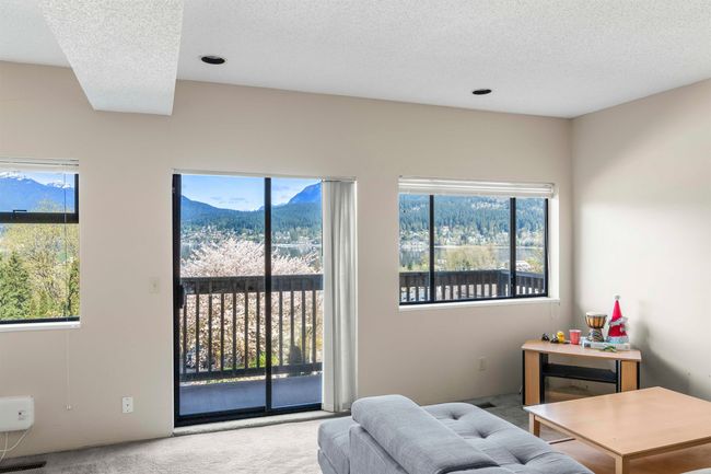 Living room with a textured ceiling, carpet, and a wealth of natural light | Image 35