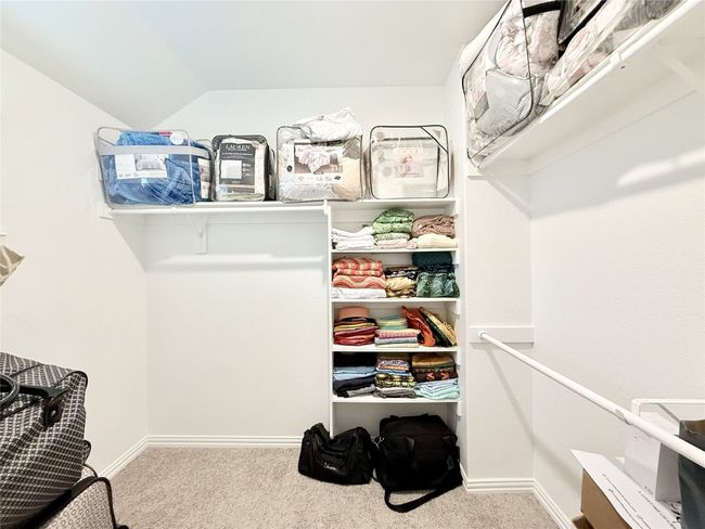 Spacious closet featuring carpet flooring and vaulted ceiling | Image 38