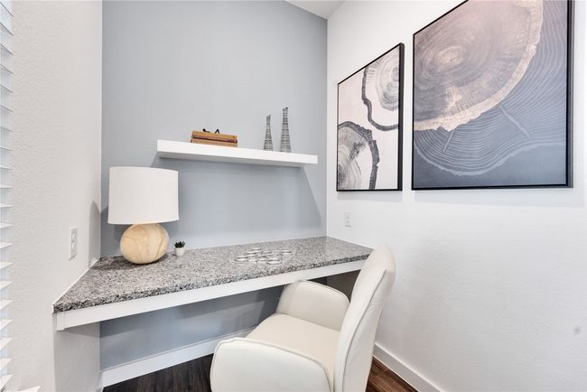 Office space with baseboards, built in desk, and wood finished floors | Image 15