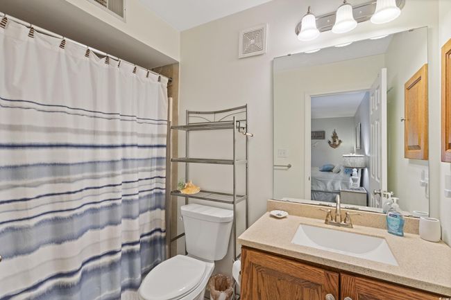 Full bath with toilet, visible vents, a shower with shower curtain, and vanity | Image 30