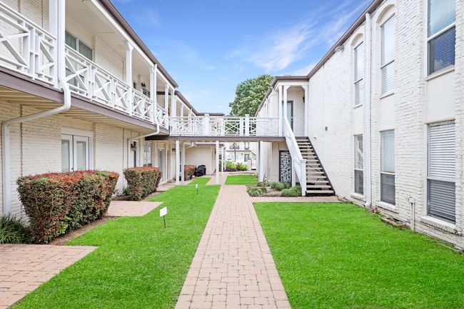 View of property's community featuring a yard and stairs | Image 17
