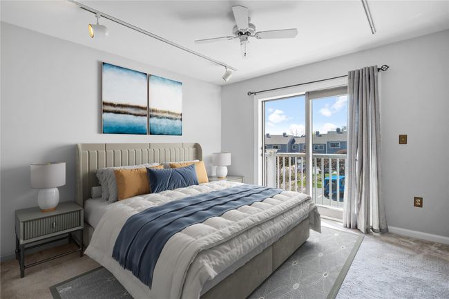 Carpeted bedroom featuring track lighting, access to exterior, and a ceiling fan | Image 10