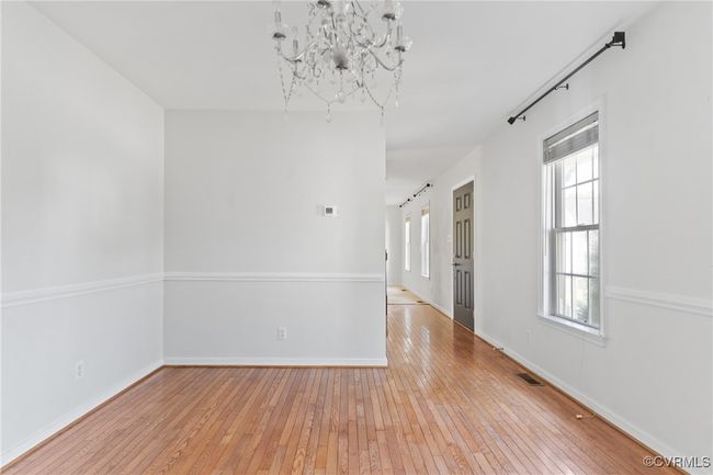 Unfurnished room featuring light wood finished floors and a chandelier | Image 6