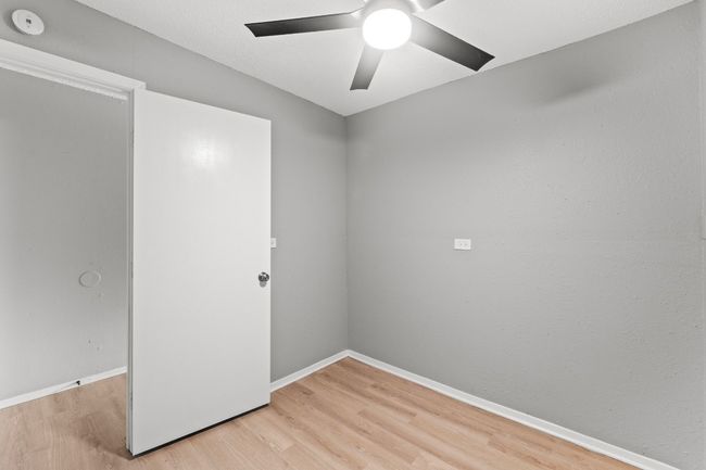 Unfurnished room with a ceiling fan, baseboards, and light wood-style floors | Image 16